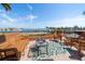 Relaxing patio setup with furniture, providing serene water views and a tranquil space at 5301 Gulf Blvd # C202, St Pete Beach, FL 33706