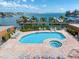 Community pool area with a unique shape and hot tub overlooking the bay at 5301 Gulf Blvd # C202, St Pete Beach, FL 33706