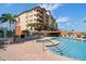 Resort-style pool and hot tub with cabanas and lounge chairs for relaxation at 5301 Gulf Blvd # C202, St Pete Beach, FL 33706