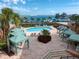 Community pool area with shaded cabanas and comfortable lounge seating overlooking the bay at 5301 Gulf Blvd # C202, St Pete Beach, FL 33706