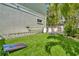 Lush backyard featuring well-maintained artificial grass with a cornhole game and outdoor grill, perfect for recreation at 536 Ontario Ave, Crystal Beach, FL 34681