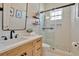Modern bathroom features a glass-enclosed shower, wood cabinets, and sleek fixtures at 536 Ontario Ave, Crystal Beach, FL 34681
