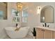 Bright bathroom with a freestanding tub, stylish lighting, and elegant vanity at 536 Ontario Ave, Crystal Beach, FL 34681