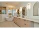 Well-lit bathroom featuring dual vanities, modern fixtures, and a luxurious soaking tub at 536 Ontario Ave, Crystal Beach, FL 34681