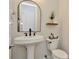 Stylish half bathroom features a sleek black faucet, modern sink, and elegant decorative accents at 536 Ontario Ave, Crystal Beach, FL 34681