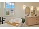 Bright bathroom featuring a soaking tub, modern vanity with double sinks, and a window with plantation shutters at 536 Ontario Ave, Crystal Beach, FL 34681