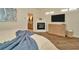 Bedroom showcasing stylish fireplace, TV, and en suite bathroom at 536 Ontario Ave, Crystal Beach, FL 34681