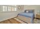 Cozy bedroom with a queen-sized bed, shuttered windows, and hardwood floors at 536 Ontario Ave, Crystal Beach, FL 34681