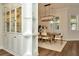 Elegant dining room featuring hardwood floors, modern lighting, built-in cabinets, and a bright window at 536 Ontario Ave, Crystal Beach, FL 34681