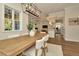 Open concept dining area featuring a wood table, white chairs, and view into the kitchen at 536 Ontario Ave, Crystal Beach, FL 34681