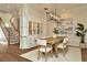 Bright dining room features hardwood floors, white chairs, and a modern light fixture at 536 Ontario Ave, Crystal Beach, FL 34681
