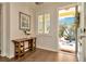 Bright foyer featuring hardwood floors, stylish console table, and a view of the beautifully landscaped front yard at 536 Ontario Ave, Crystal Beach, FL 34681