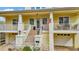 Welcoming front entrance with brick stairs, white railings, and a covered porch on a charming two-story home at 536 Ontario Ave, Crystal Beach, FL 34681