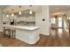 Spacious kitchen with white cabinetry, an island with seating, and stainless steel appliances at 536 Ontario Ave, Crystal Beach, FL 34681