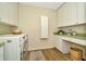Bright laundry room with ample storage, modern appliances and a built in desk at 536 Ontario Ave, Crystal Beach, FL 34681