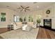 Bright living room with a fireplace, hardwood floors, and large windows at 536 Ontario Ave, Crystal Beach, FL 34681