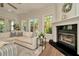 Cozy living room with fireplace, hardwood floors, and an abundance of natural light at 536 Ontario Ave, Crystal Beach, FL 34681