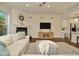 Bright living room with fireplace, media center, and hardwood floors open to the kitchen at 536 Ontario Ave, Crystal Beach, FL 34681