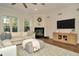 Comfortable living room with a fireplace, hardwood floors, a large tv, and an area rug at 536 Ontario Ave, Crystal Beach, FL 34681