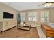 Bright main bedroom with hardwood floors, plantation shutters, and stylish furnishings with a lovely rug at 536 Ontario Ave, Crystal Beach, FL 34681