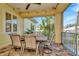 Covered patio features a dining table and seating with views of the lush backyard at 536 Ontario Ave, Crystal Beach, FL 34681