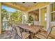 Charming covered patio with outdoor dining and views of the lush tropical landscape at 536 Ontario Ave, Crystal Beach, FL 34681