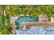 Aerial view of a private backyard pool and spa surrounded by a brick patio and mature palm trees at 536 Ontario Ave, Crystal Beach, FL 34681