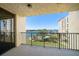 A condo balcony overlooking landscaped grounds, pool, and picturesque waterfront views at 700 Island Way # 404, Clearwater Beach, FL 33767