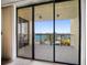 A stunning waterfront view of a pool and lush landscaping from a private balcony at 700 Island Way # 404, Clearwater Beach, FL 33767