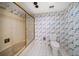 Bathroom with a toilet, shower with sliding doors, and wallpaper at 700 Island Way # 404, Clearwater Beach, FL 33767