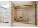 Bathroom with a tiled tub with sliding doors, vanity, and patterned wallpaper at 700 Island Way # 404, Clearwater Beach, FL 33767