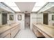 Spacious bathroom with a double sink vanity, mirrors and patterned wallpaper at 700 Island Way # 404, Clearwater Beach, FL 33767