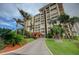 A luxurious condo community with beautiful tropical landscaping and paver driveway at 700 Island Way # 404, Clearwater Beach, FL 33767