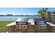 Outdoor stainless steel grills on a brick stand sit near a stunning waterfront at 700 Island Way # 404, Clearwater Beach, FL 33767