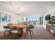 Bright living room featuring modern furnishings, a crystal chandelier, and large windows with city views at 700 Island Way # 404, Clearwater Beach, FL 33767