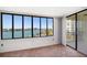 A condo living room and balcony with floor-to-ceiling windows overlooking scenic waterfront views at 700 Island Way # 404, Clearwater Beach, FL 33767