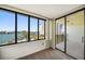 Condo living room with floor-to-ceiling windows offering spectacular views of the waterfront and pool at 700 Island Way # 404, Clearwater Beach, FL 33767
