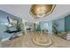 A stylish condo lobby featuring tile floors, art, statement light fixtures, and seating at 700 Island Way # 404, Clearwater Beach, FL 33767