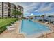 Community pool overlooks the bay and the Intracoastal, and is surrounded by lounge chairs at 700 Island Way # 404, Clearwater Beach, FL 33767