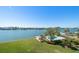 Stunning waterfront property with a pool, dock, boat, and lush green lawn at 700 Island Way # 404, Clearwater Beach, FL 33767