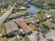 Aerial view of home with mature trees in a neighborhood with canal access at 7038 Mccray Dr, Hudson, FL 34667