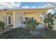 Inviting covered front porch with white lattice detail and a cozy sitting area at 7038 Mccray Dr, Hudson, FL 34667