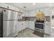 Charming kitchen with stainless steel appliances, tile backsplash, and bright white cabinetry at 7038 Mccray Dr, Hudson, FL 34667