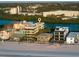 Stunning aerial view of beachfront homes with a river and lush landscape at 74 Gulf Blvd # 2B, Indian Rocks Beach, FL 33785