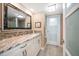 Bathroom featuring a modern vanity with marble counters, mosaic backsplash, and white cabinets at 74 Gulf Blvd # 2B, Indian Rocks Beach, FL 33785