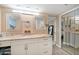 Bathroom featuring a marble vanity with dual mirrors and neutral color tones at 74 Gulf Blvd # 2B, Indian Rocks Beach, FL 33785