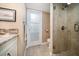 Bathroom with granite countertop vanity and a glass-enclosed shower with a rainfall showerhead at 74 Gulf Blvd # 2B, Indian Rocks Beach, FL 33785