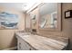 Bathroom featuring a spacious vanity with stone countertops, decorative fixtures, and ample storage space at 74 Gulf Blvd # 2B, Indian Rocks Beach, FL 33785