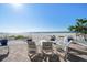 Charming patio with seating overlooking the pristine white sand beach and glistening ocean view at 74 Gulf Blvd # 2B, Indian Rocks Beach, FL 33785
