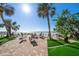 Relaxing beachside seating area with palm trees and ocean views at 74 Gulf Blvd # 2B, Indian Rocks Beach, FL 33785